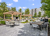 Thumbnail 43 of 53 - A patio with a table and chairs under a pergola.