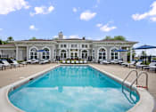 Thumbnail 36 of 53 - A large white building with a pool in front.