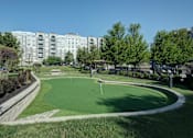 Thumbnail 48 of 53 - A golf course is located in front of apartment buildings.