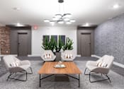 Thumbnail 47 of 47 - A modern living room with a wooden coffee table and grey chairs.