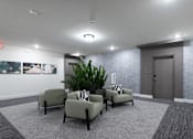 Thumbnail 43 of 47 - A waiting room with grey chairs and a grey carpet.