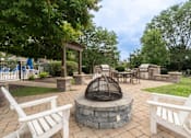 Thumbnail 10 of 23 - A backyard with a fire pit and chairs.