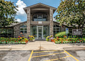 Thumbnail 7 of 23 - The front of a building with a sign that says "Leasing Center".