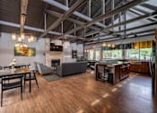 Thumbnail 27 of 44 - A modern open plan living and dining room with a fireplace.