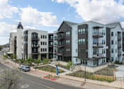 Thumbnail 19 of 19 - A modern apartment complex with multiple buildings and balconies.