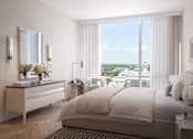 Thumbnail 1 of 14 - A bedroom with a large bed, a dresser with a mirror, and a view of the city outside the window.
