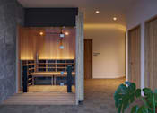 Thumbnail 9 of 14 - A room with a wooden bench and a door.
