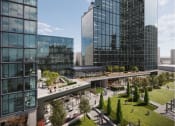 Thumbnail 10 of 22 - a rendering of a park between two tall buildings at AVE Hamilton Green - 25 Cottage Apartments, New York
