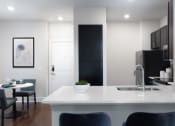 Thumbnail 4 of 13 - a kitchen and dining area in a 555 waverly unit at AVE Las Colinas, Irving