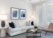 Thumbnail 11 of 13 - a living room with a white couch and two paintings on the wall at AVE Las Colinas, Texas