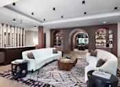 Thumbnail 12 of 19 - A modern living room with a white sofa and a patterned rug at AVE Paradise Valley, Phoenix, 85032