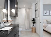 Thumbnail 5 of 19 - A modern bathroom with a black countertop and white fixtures at AVE Paradise Valley, Phoenix, 85032