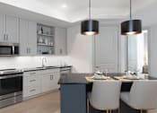 Thumbnail 8 of 19 - A modern kitchen with a dark countertop and white cabinets at AVE Paradise Valley, Phoenix, 85032