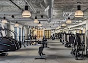 Thumbnail 19 of 30 - A gym with a variety of exercise equipment.