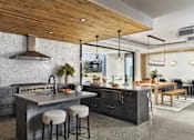 Thumbnail 21 of 30 - A modern kitchen with a wooden ceiling and a marble countertop.