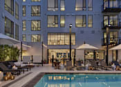 Thumbnail 13 of 30 - A modern building with a pool in front.