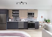 Thumbnail 3 of 30 - a bedroom with a kitchen with a stove and a sink at AVE Santa Clara, Santa Clara
