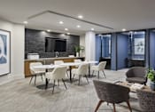 Thumbnail 13 of 19 - A modern kitchen with a dining table set up.