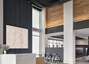 Thumbnail 7 of 19 - A reception area with a white reception desk and a bicycle rack.
