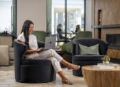 Thumbnail 13 of 20 - a woman sitting in a chair with a laptop at AVE Phoenix Terra, Phoenix, 85003