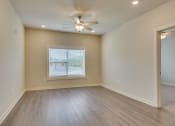 Thumbnail 18 of 18 - an empty living room with a ceiling fan at The Augustan, Augusta, Georgia
