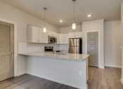 Thumbnail 7 of 18 - a kitchen with white cabinets and a granite counter top at The Augustan, Georgia