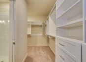 Thumbnail 9 of 18 - a walk in closet with white cabinets and a tiled floor at The Augustan, Augusta, 30901