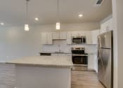 Thumbnail 4 of 18 - a kitchen with stainless steel appliances and a granite counter top at The Augustan, Georgia, 30901