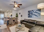 Thumbnail 1 of 12 - Open living room space with dining area at McHenry Square Apartments, Augusta