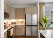 Thumbnail 16 of 39 - Kitchen with stainless steel appliances and custom cabinetry