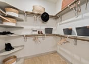Thumbnail 28 of 39 - Walk-in closet with custom wood shelving