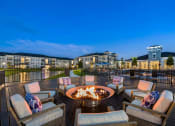 Thumbnail 34 of 39 - Lakeside fire pit surrounded by comfortable seating