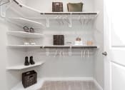 Thumbnail 20 of 37 - Walk-in closet with wood shelving 