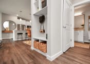 Thumbnail 23 of 37 - A view of the mudroom, bath and part of the kitchen with wood style flooring