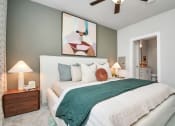 Thumbnail 26 of 37 - Bedroom with ceiling fan and the door open to the bathroom