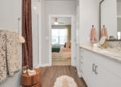 Thumbnail 29 of 37 - Bathroom with walk-in shower and door open to the bedroom
