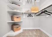 Thumbnail 32 of 37 - Walk-in closet with custom wood shelving