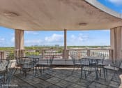 Thumbnail 42 of 43 - the patio has tables and chairs and a view of the water