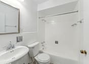 Thumbnail 12 of 28 - a bathroom with a sink toilet and bathtub