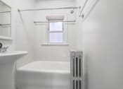 Thumbnail 18 of 18 - a bathroom with a tub and a sink