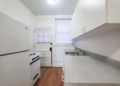 Thumbnail 15 of 18 - a kitchen with white cabinets and a white stove top oven