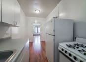 Thumbnail 16 of 18 - a kitchen with white cabinets and white appliances