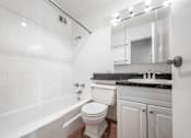 Thumbnail 29 of 36 - a bathroom with a sink toilet and bathtub