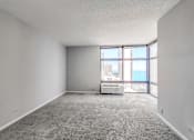 Thumbnail 26 of 36 - an empty room with a large window and an air conditioner
