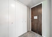Thumbnail 21 of 36 - a bedroom with a medium sized white wardrobe and a large metal door
