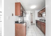 Thumbnail 22 of 36 - a kitchen with a white refrigerator freezer next to a stove top oven