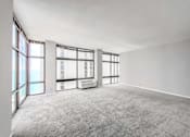 Thumbnail 23 of 36 - a bedroom with a large window and white walls
