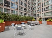 Thumbnail 6 of 45 - a seating area with a couch and chairs in front of an office building