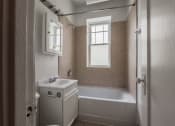 Thumbnail 12 of 18 - a bathroom with a bathtub and a sink