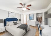 Thumbnail 6 of 27 - a bedroom with a bed and a ceiling fan